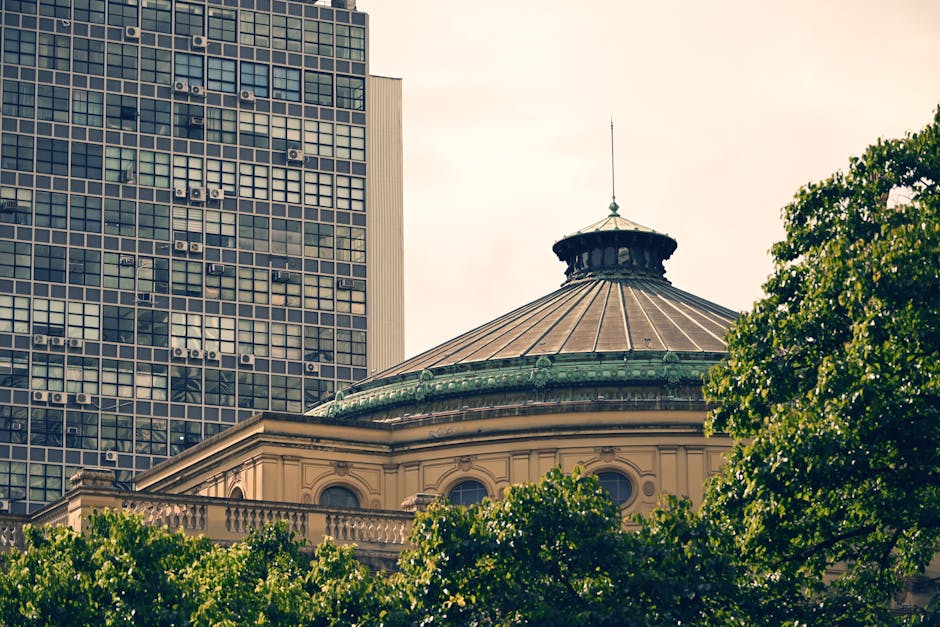 A classic architectural dome juxtaposed with a modern cityscape structure.