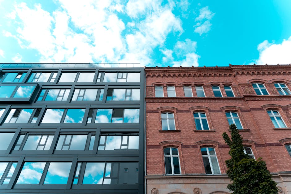 A juxtaposition of contemporary and historic architecture under a bright blue sky.