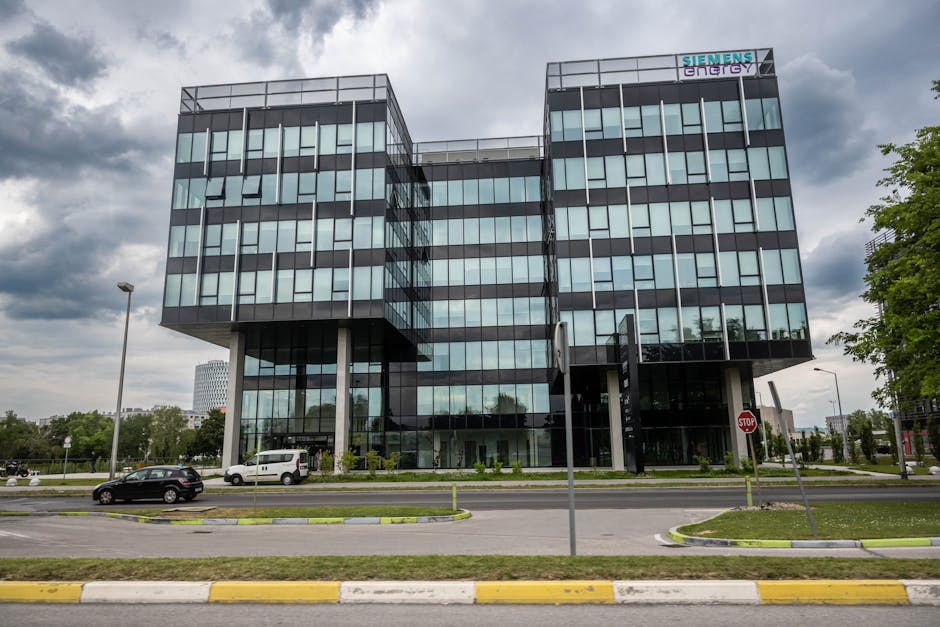 A sleek, modern office building in Zagreb, Croatia under a cloudy sky, reflecting urban architecture.