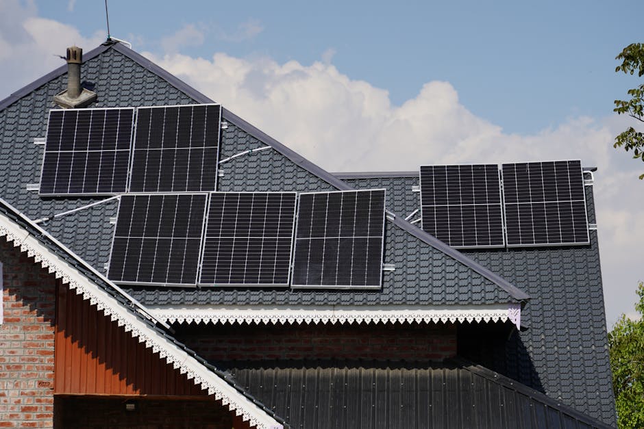 Rooftop solar panels on a house in Srinagar against a blue sky backdrop.