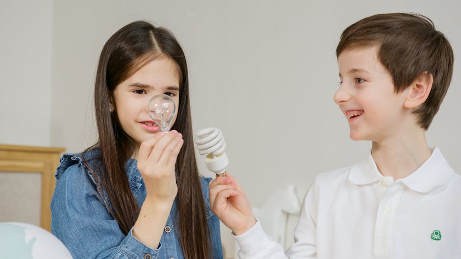 Two children learning about energy efficiency with lightbulbs indoors.
