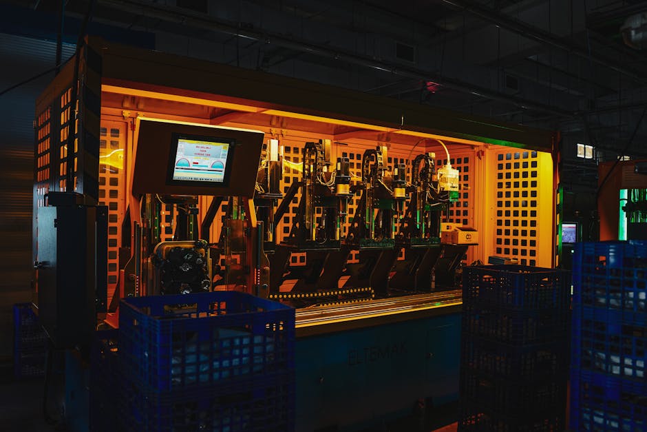 A complex piece of machinery in a dark industrial setting with vibrant lighting.