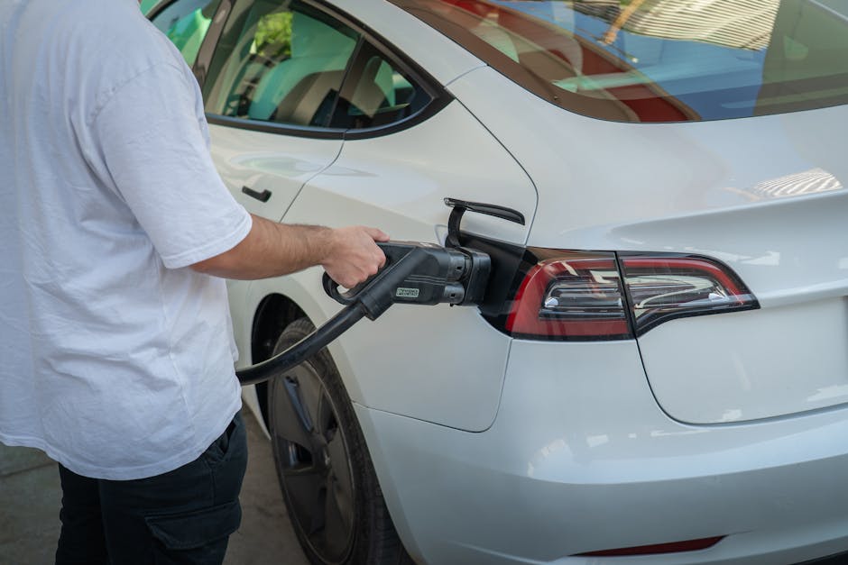 Electric car being charged at a station, highlighting eco-friendly transportation.