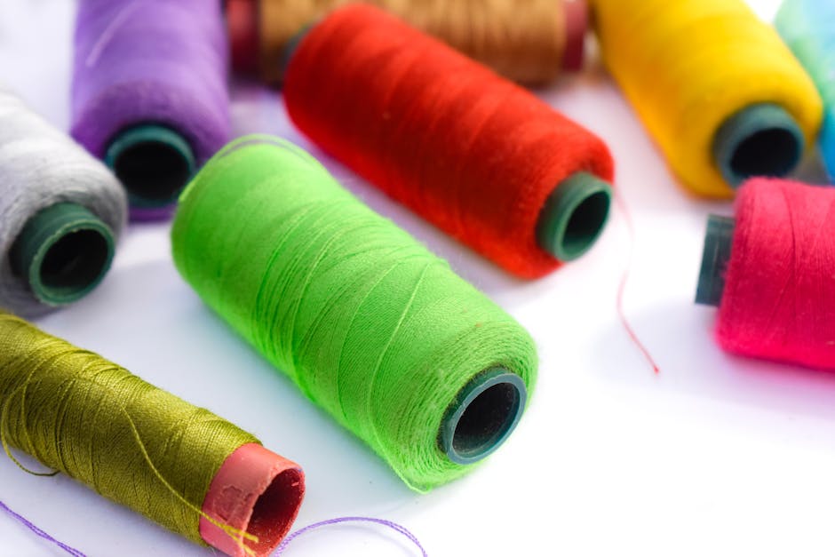 Vibrant close-up of assorted colorful thread spools, perfect for sewing and needlework.