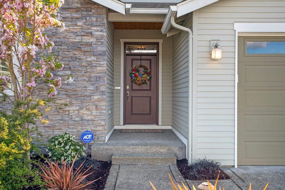 Inviting front entrance of a modern home in Tacoma, WA with spring floral decor.
